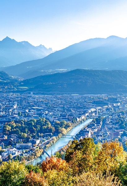 Hungerburg view of Innsbruck cityscape with mountains and river.