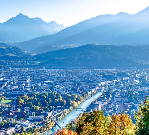 Hungerburg view of Innsbruck cityscape with mountains and river.