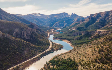 River winding through a mountain valley in Patagonia, surrounded by dense forests and rugged peaks.