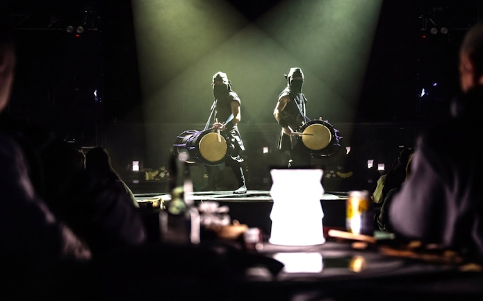 Drummers performing on stage in Tokyo, blending traditional and modern elements.