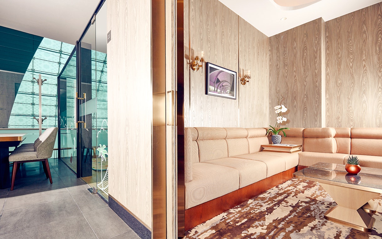 Plaza Premium Lounge seating area with modern decor at Dubai International Airport.
