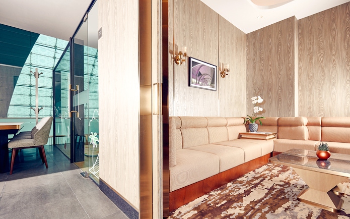Plaza Premium Lounge seating area with modern decor at Dubai International Airport.