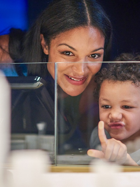 Child and adult exploring Melbourne Skydeck model at Eureka Tower.