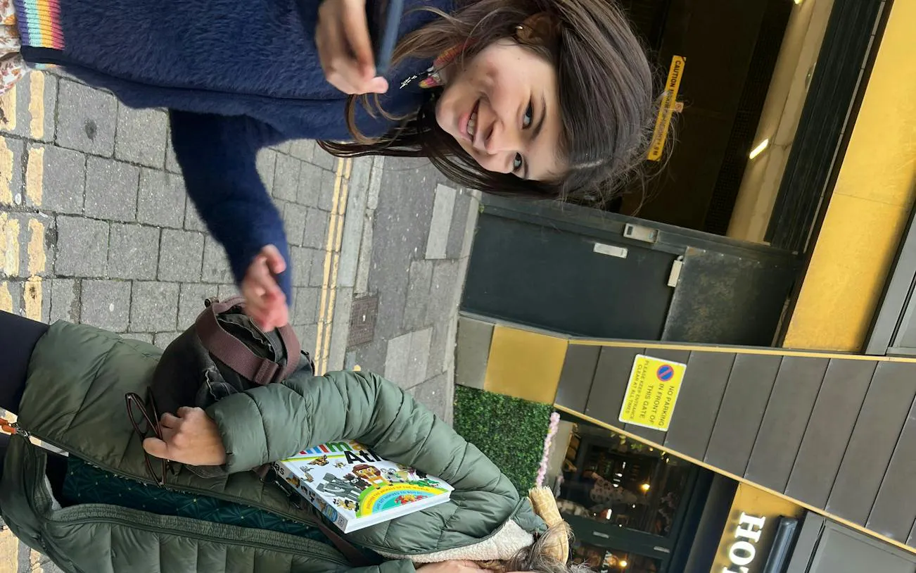 Participants engaging in Brighton Secret Society Mystery game on city street.