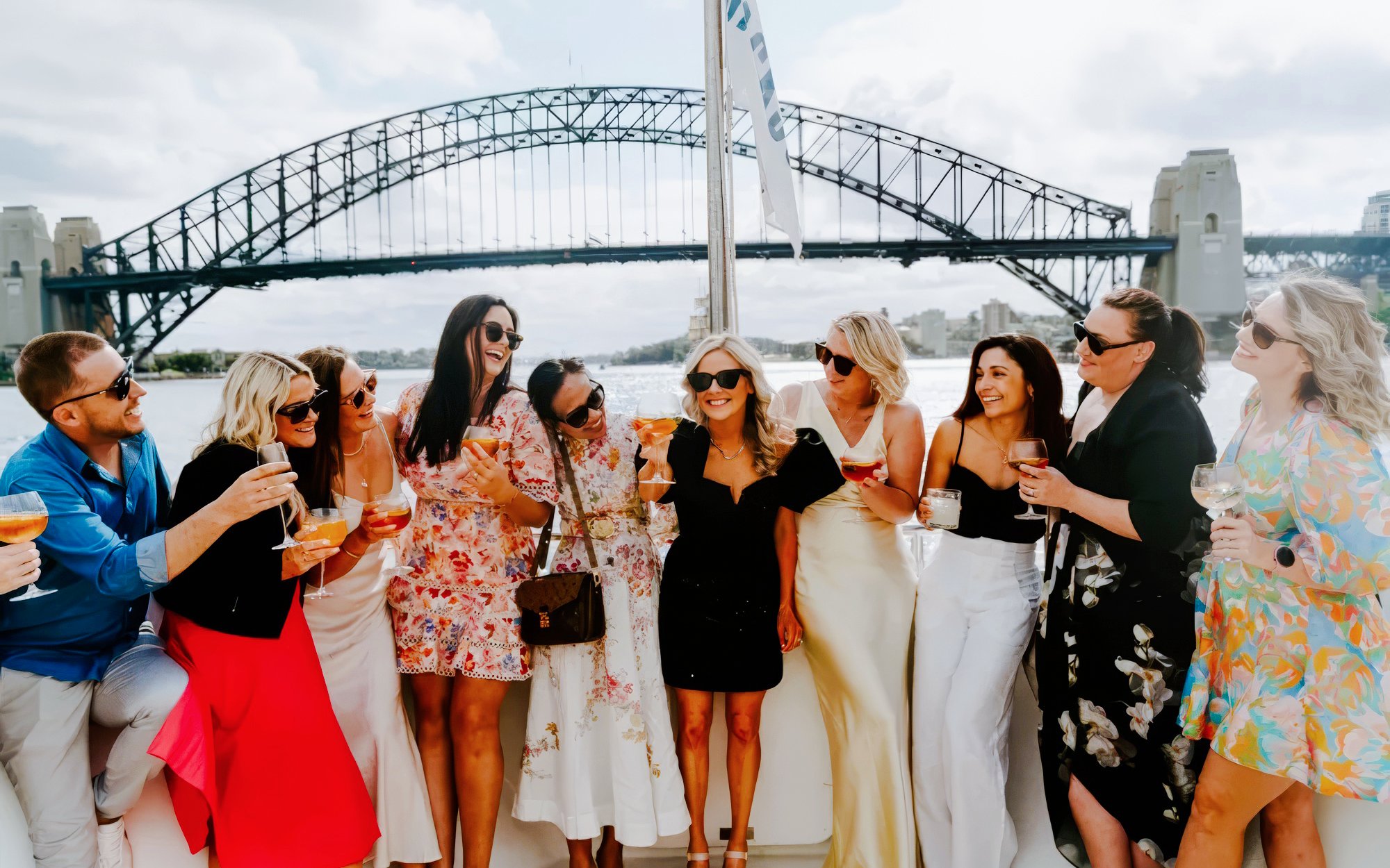 Group enjoying drinks on The Jackson with Sydney Harbour Bridge in the background.