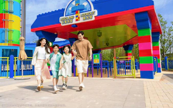Family walking near the colorful entrance of LEGOLAND Lookout in Shanghai.