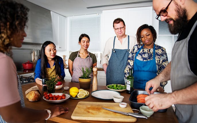 Group preparing ingredients during Ortigia market cooking class.