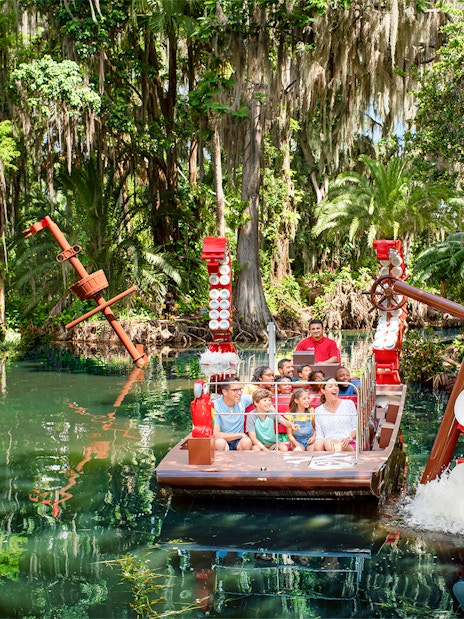 Pirate-themed boat ride at Pirate River Quest, LEGOLAND Florida, surrounded by lush greenery.