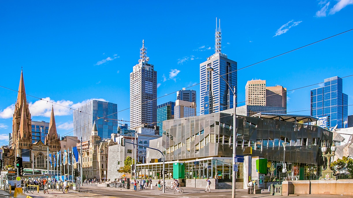 Federation Square in Melbourne with modern architecture and people gathering.