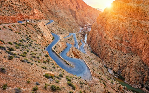 Winding road through Dades Gorge in Atlas Mountains, Morocco at sunset.