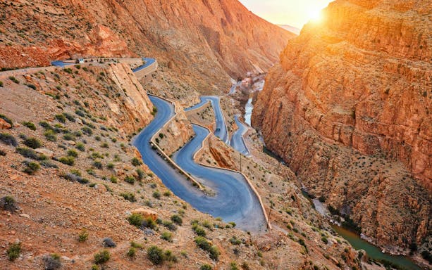 Winding road through Dades Gorge in Atlas Mountains, Morocco at sunset.