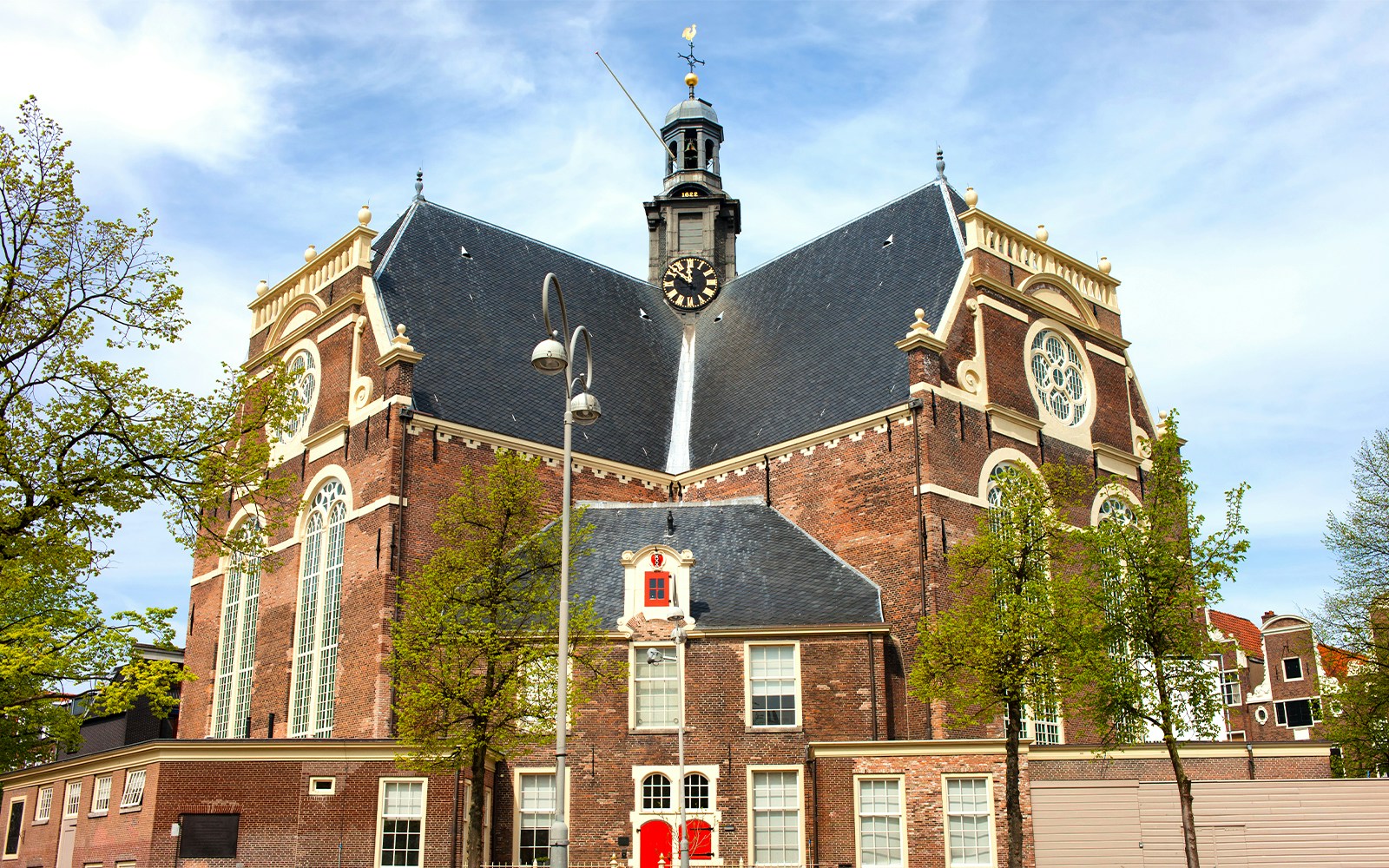 Noorderkerk exterior with clock tower and trees, Amsterdam.