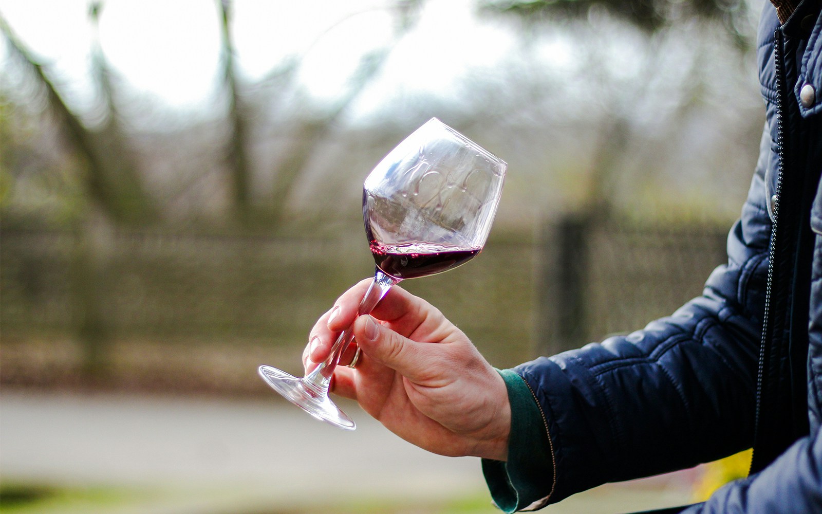 Outdoor red wine tasting experience on a chilly afternoon.