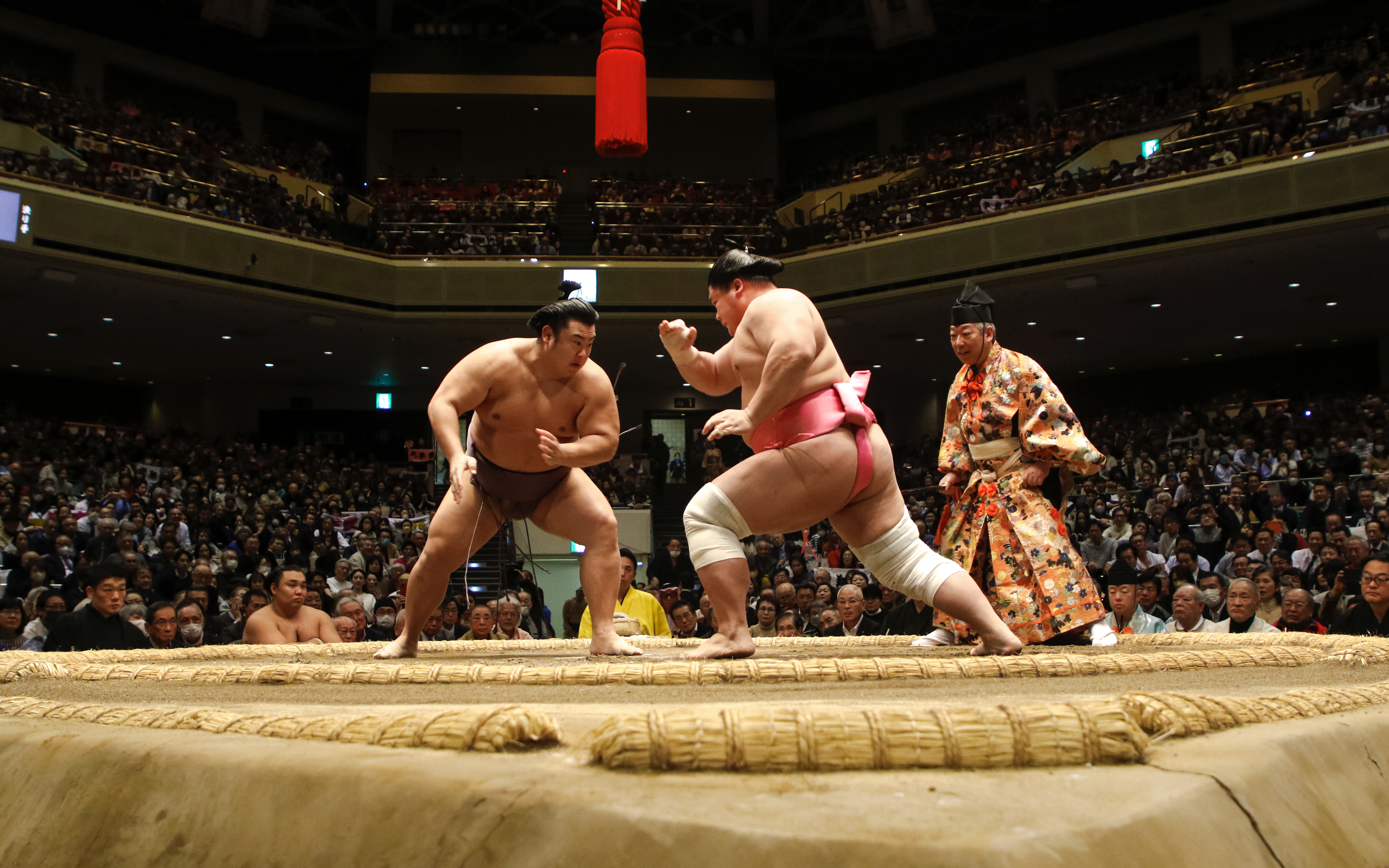 Sumo wrestlers face off in the Nagoya Grand Sumo Tournament arena.