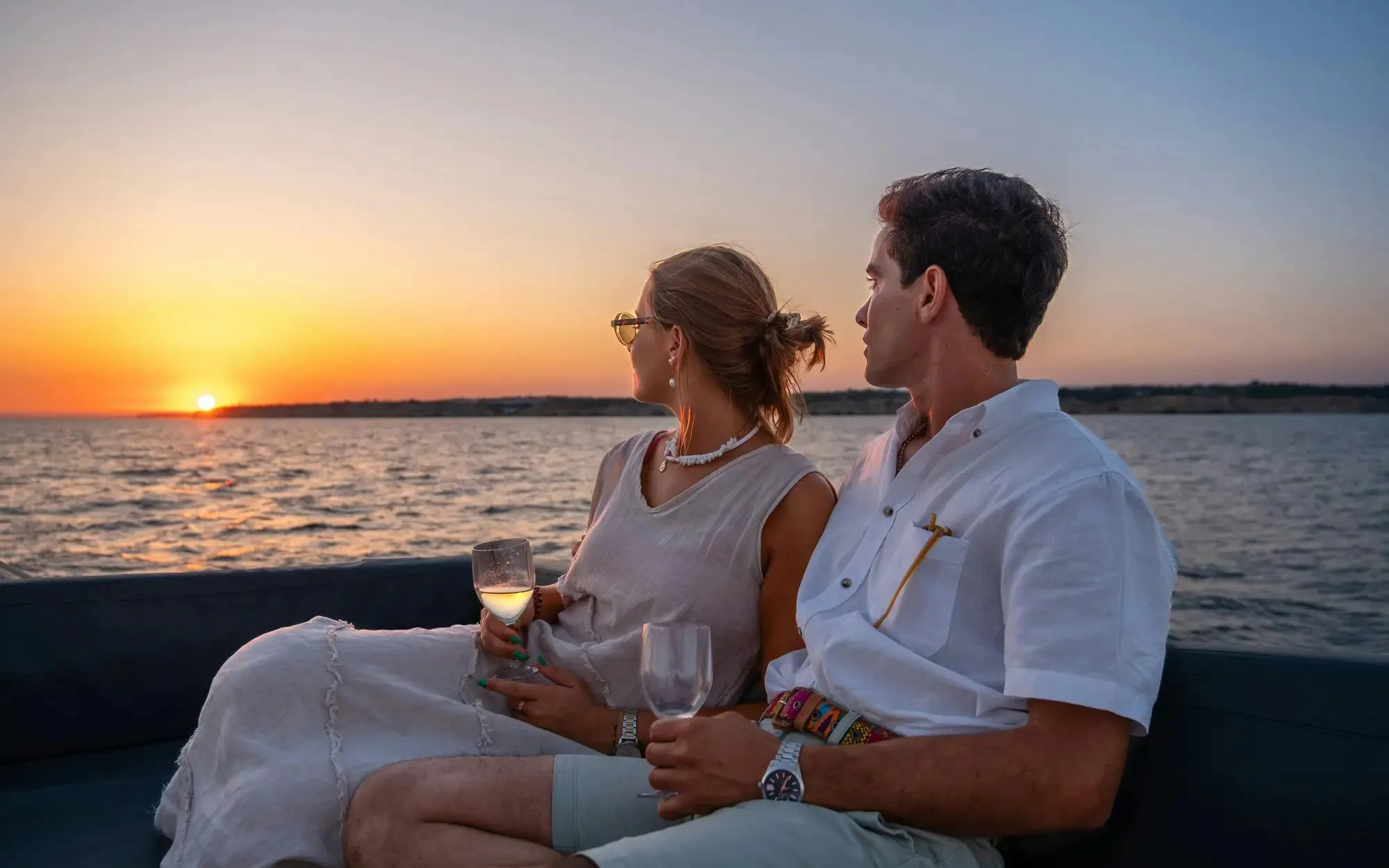 Couple enjoying sunset on Algarve sailing tour from Vilamoura.
