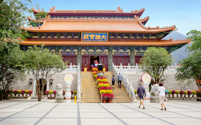 Po Lin Monastery entrance with visitors, Ngong Ping 360 Cable Car tour.
