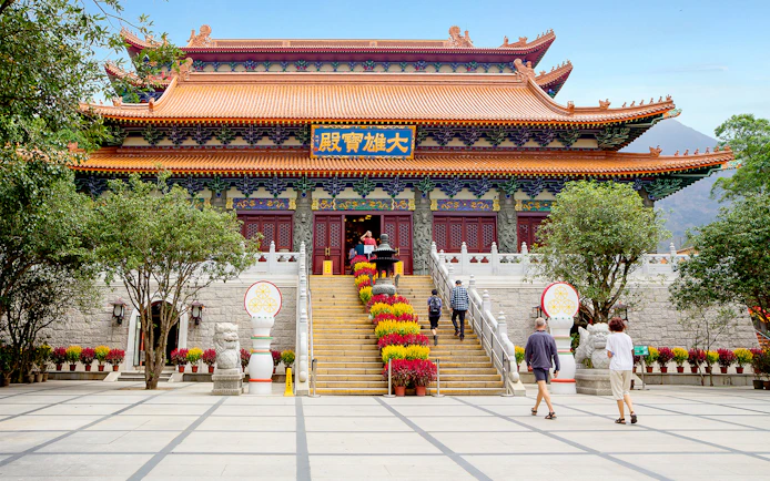 Po Lin Monastery entrance with visitors, Ngong Ping 360 Cable Car tour.