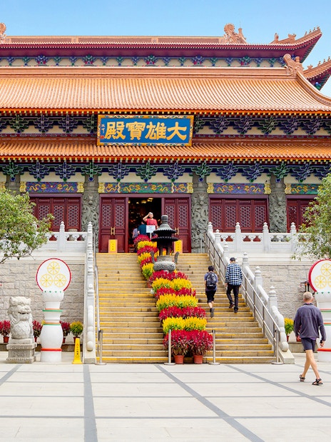 Po Lin Monastery entrance with visitors, Ngong Ping 360 Cable Car tour.