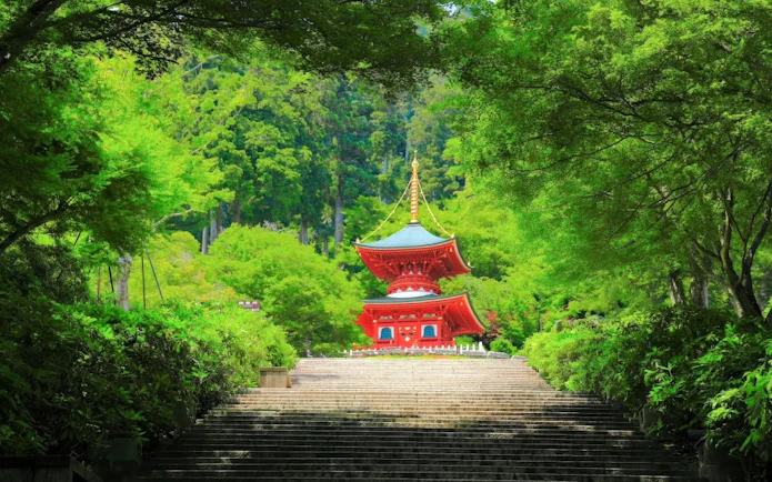 Pagoda surrounded by lush greenery at Katsuo-ji Temple, Osaka.