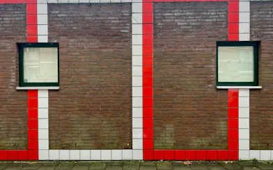Brick wall with red and white tile stripes and two windows, Delft Food Tour, The Hague.