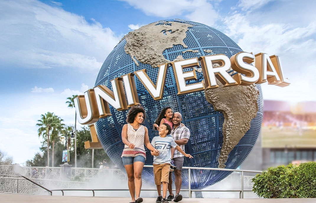 Family walking in front of the Universal Globe at Universal Studios Resort, Orlando.