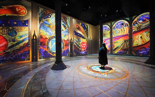 Guests viewing digital art projections at ARTECHOUSE New York exhibit.