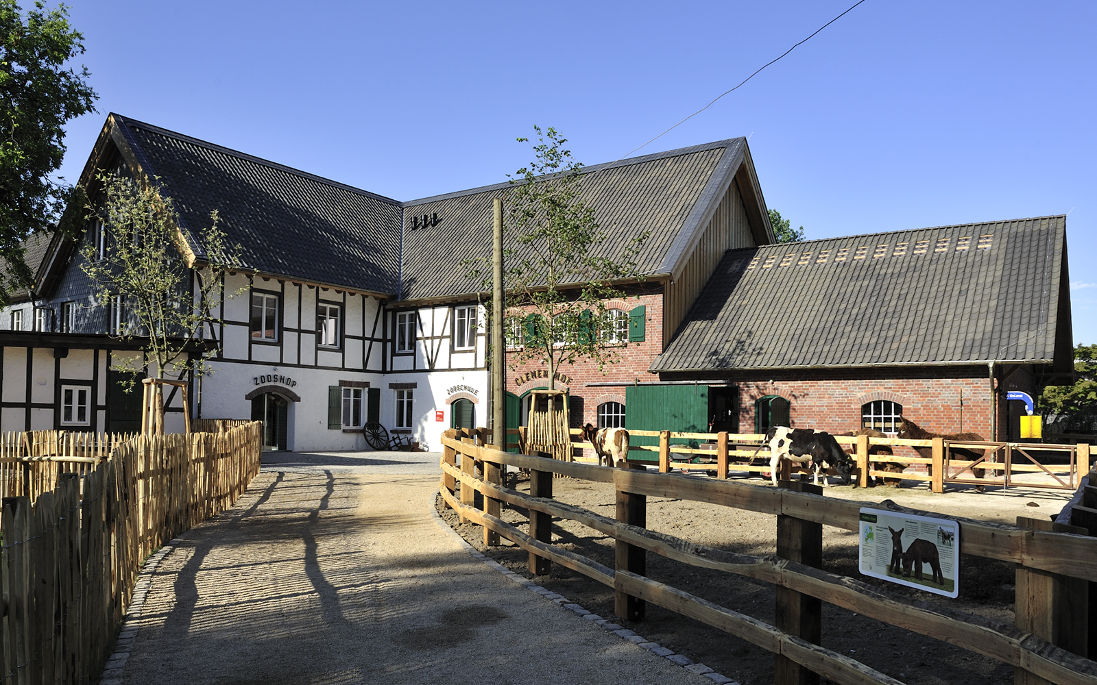 Cologne Zoo Shop exterior with timber-framed building and fenced pathway.