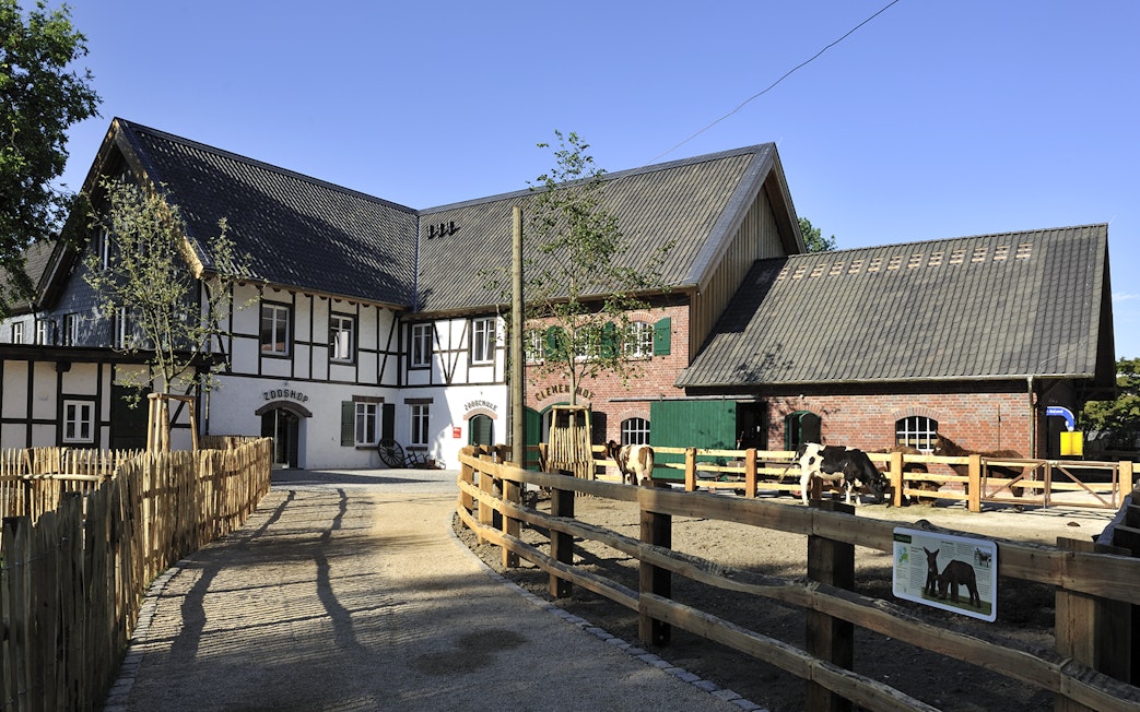 Cologne Zoo Shop exterior with timber-framed building and fenced pathway.