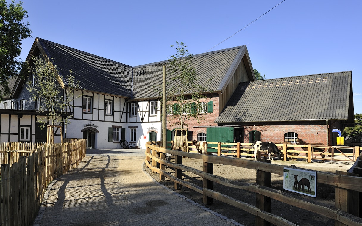 Cologne Zoo Shop exterior with timber-framed building and fenced pathway.