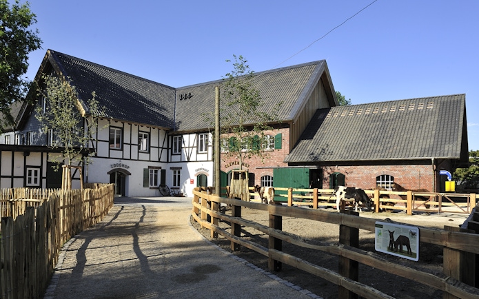 Cologne Zoo Shop exterior with timber-framed building and fenced pathway.
