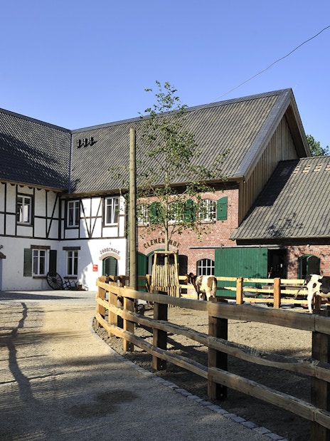Cologne Zoo Shop exterior with timber-framed building and fenced pathway.