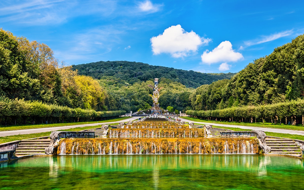 Fountain with sculptures and greenery in the Gardens of Royal Palace of Caserta, Italy.