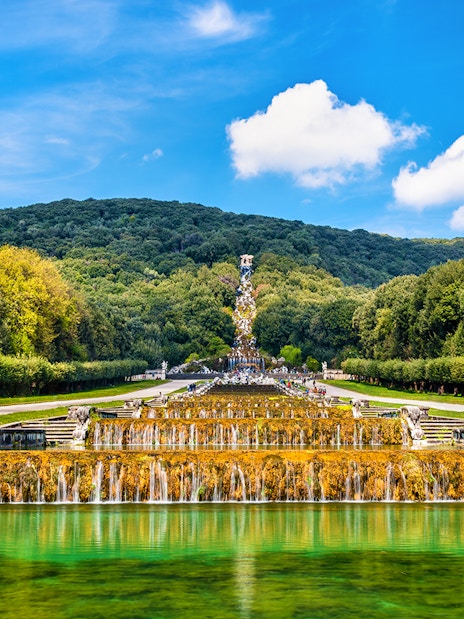Fountain with sculptures and greenery in the Gardens of Royal Palace of Caserta, Italy.