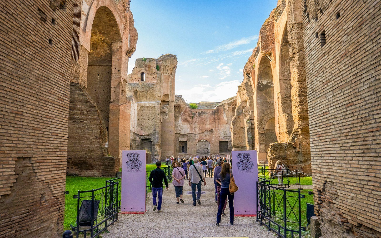 Opera performance at Baths of Caracalla, Rome, with audience seated in ancient ruins.
