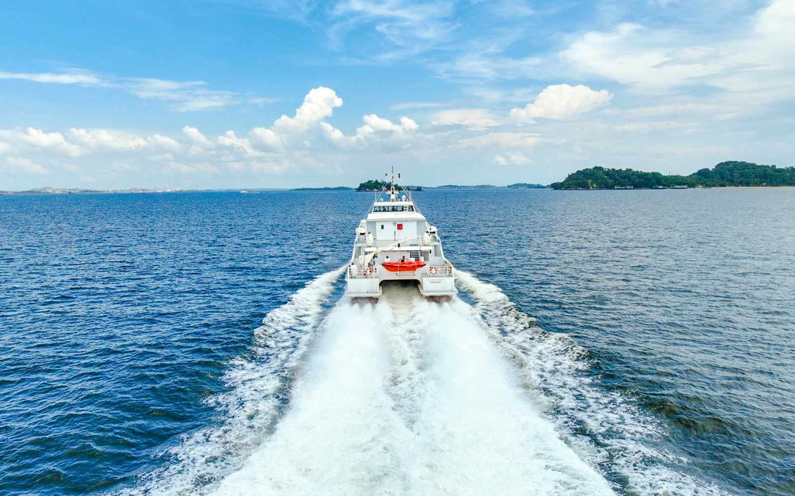 Ferry traveling from Singapore to Bintan across the open sea.