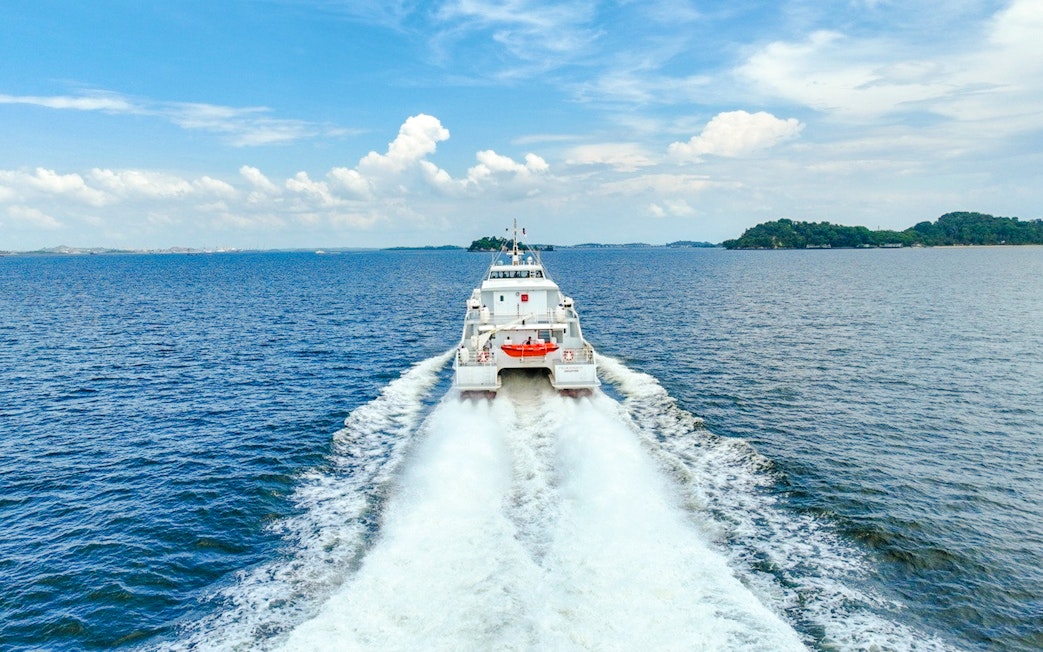 Ferry traveling from Singapore to Bintan across the open sea.