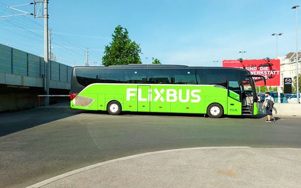 FlixBus parked at a station, offering transport to Efteling from Amsterdam.