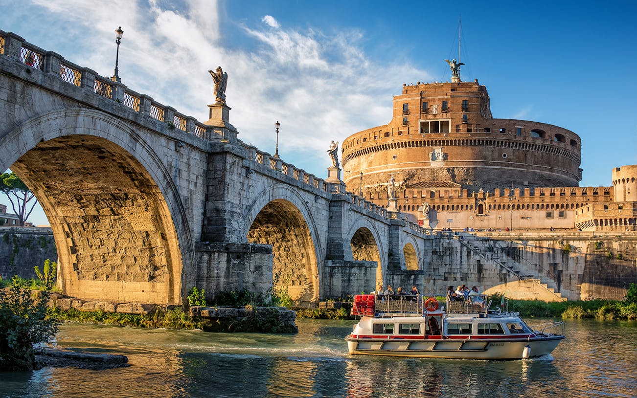 Cruise boat on the Tiber River near Castel Sant'Angelo, Rome.