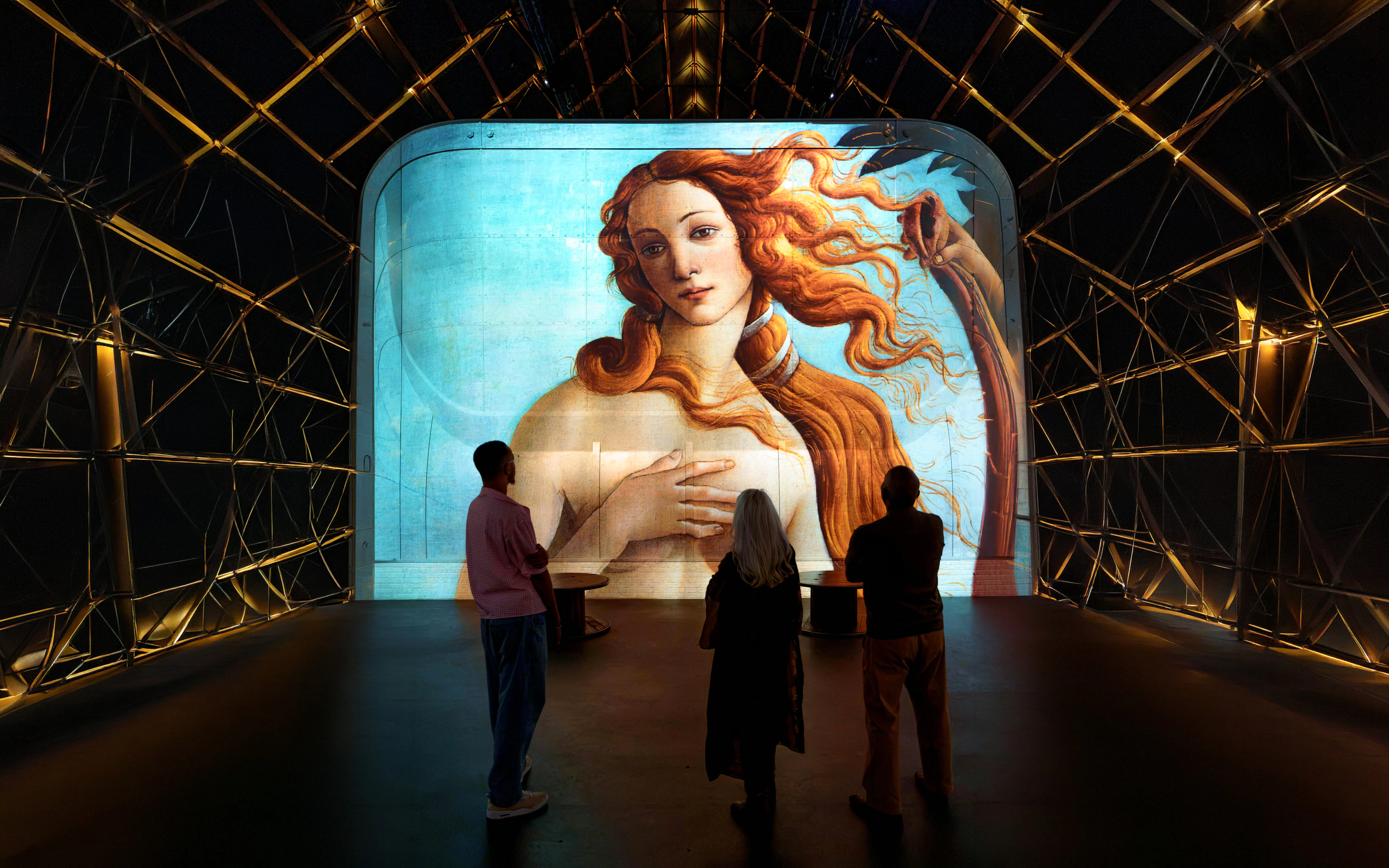Visitors viewing "The Birth of Venus" projection at Fabrique des Lumières exhibit.