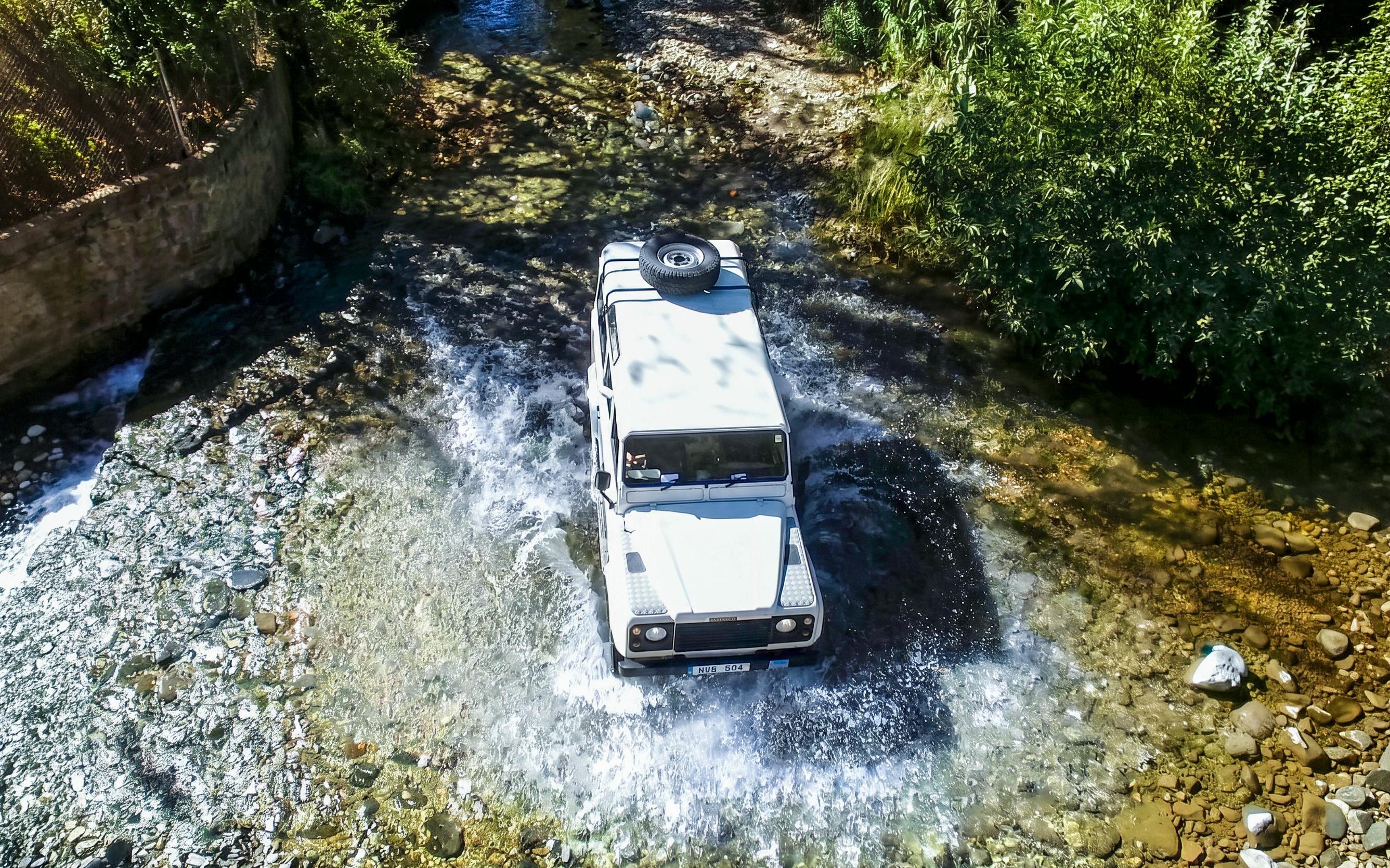 Jeep crossing a stream in the Troodos Mountains, Cyprus during a safari tour.