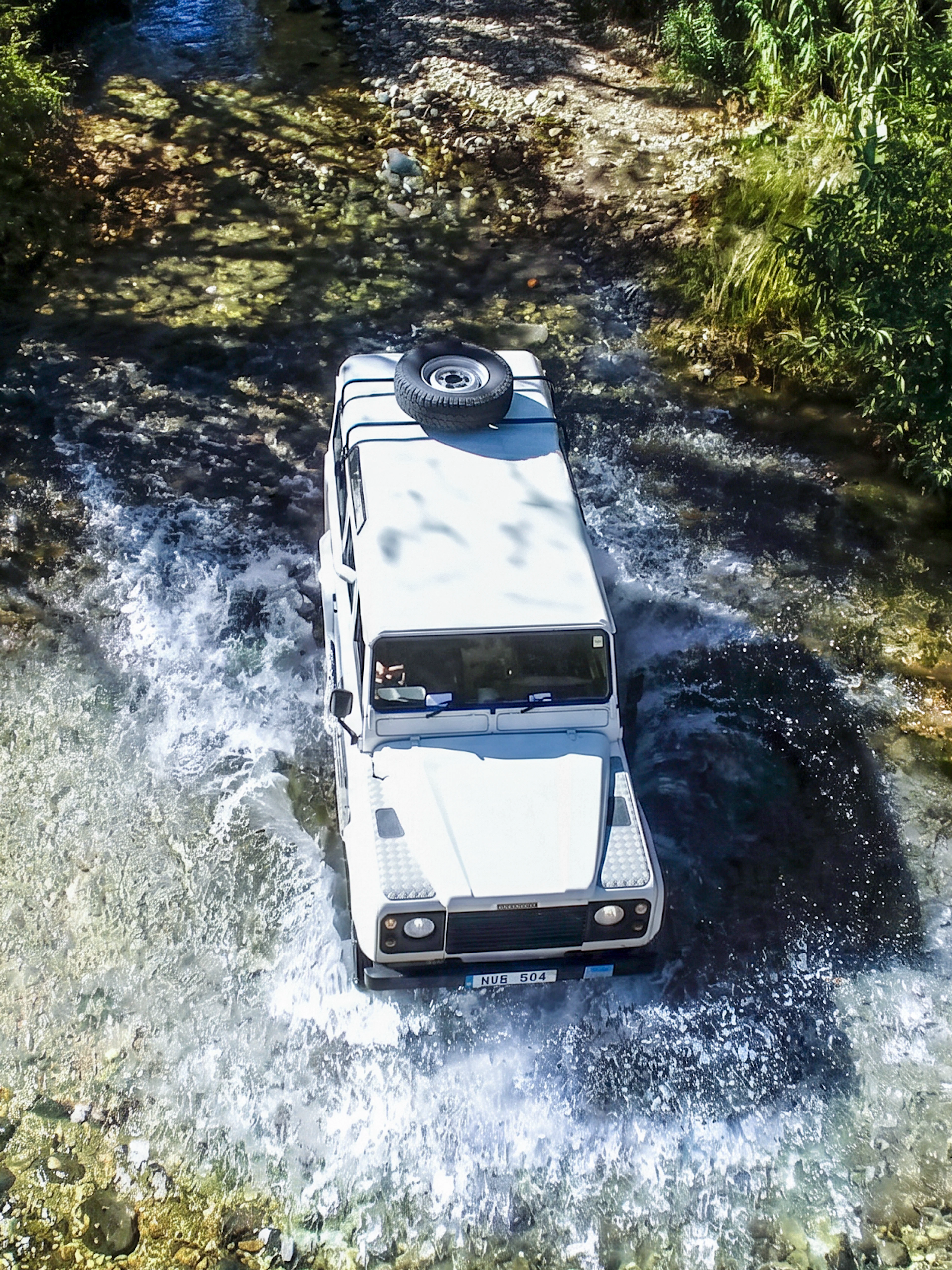 Jeep crossing a stream in the Troodos Mountains, Cyprus during a safari tour.
