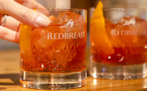 Redbreast whiskey glass with ice and orange peel at Jameson Distillery Midleton, Cork.