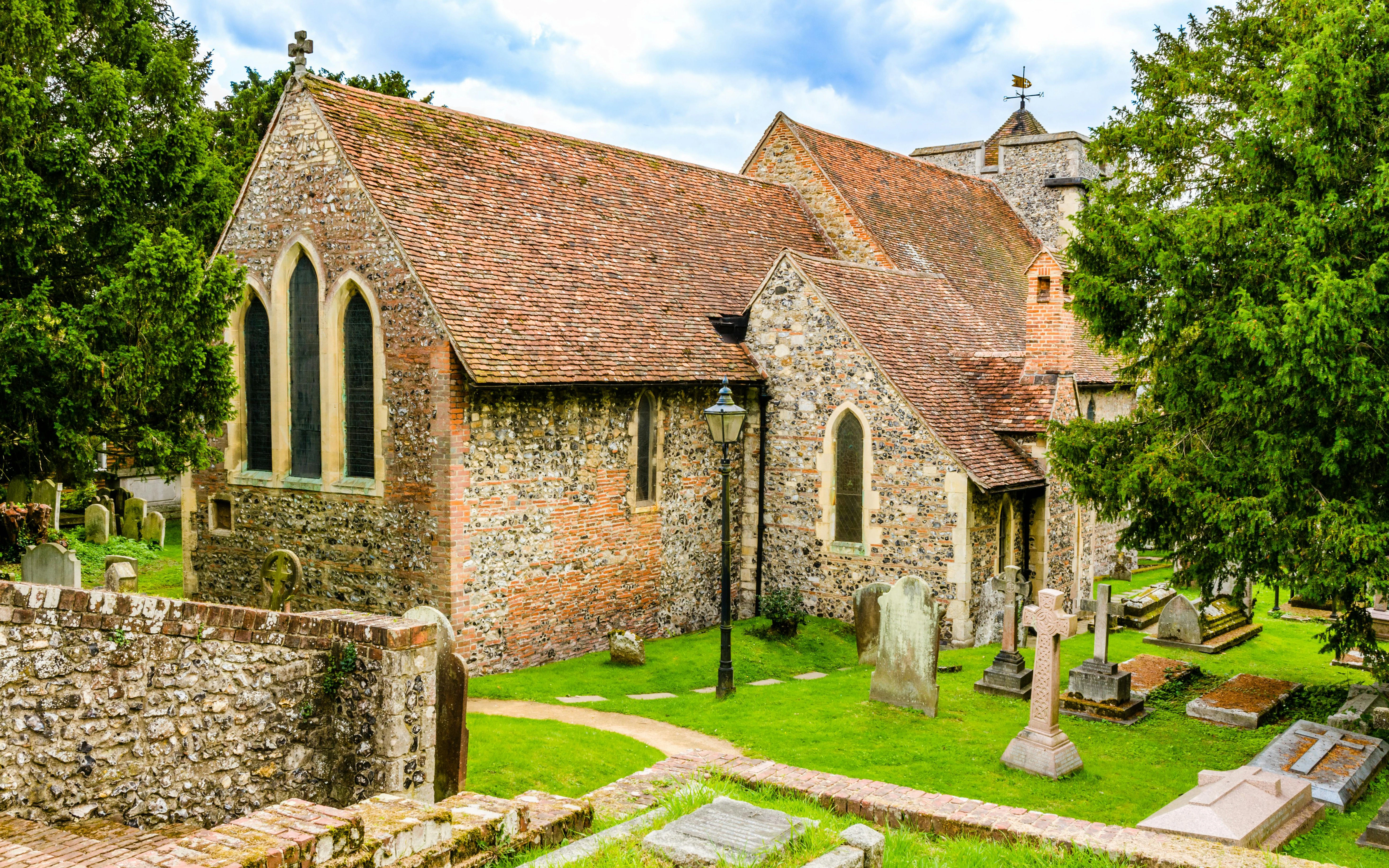 St Martin's Church in Canterbury, UK, with historic graveyard and stone architecture.