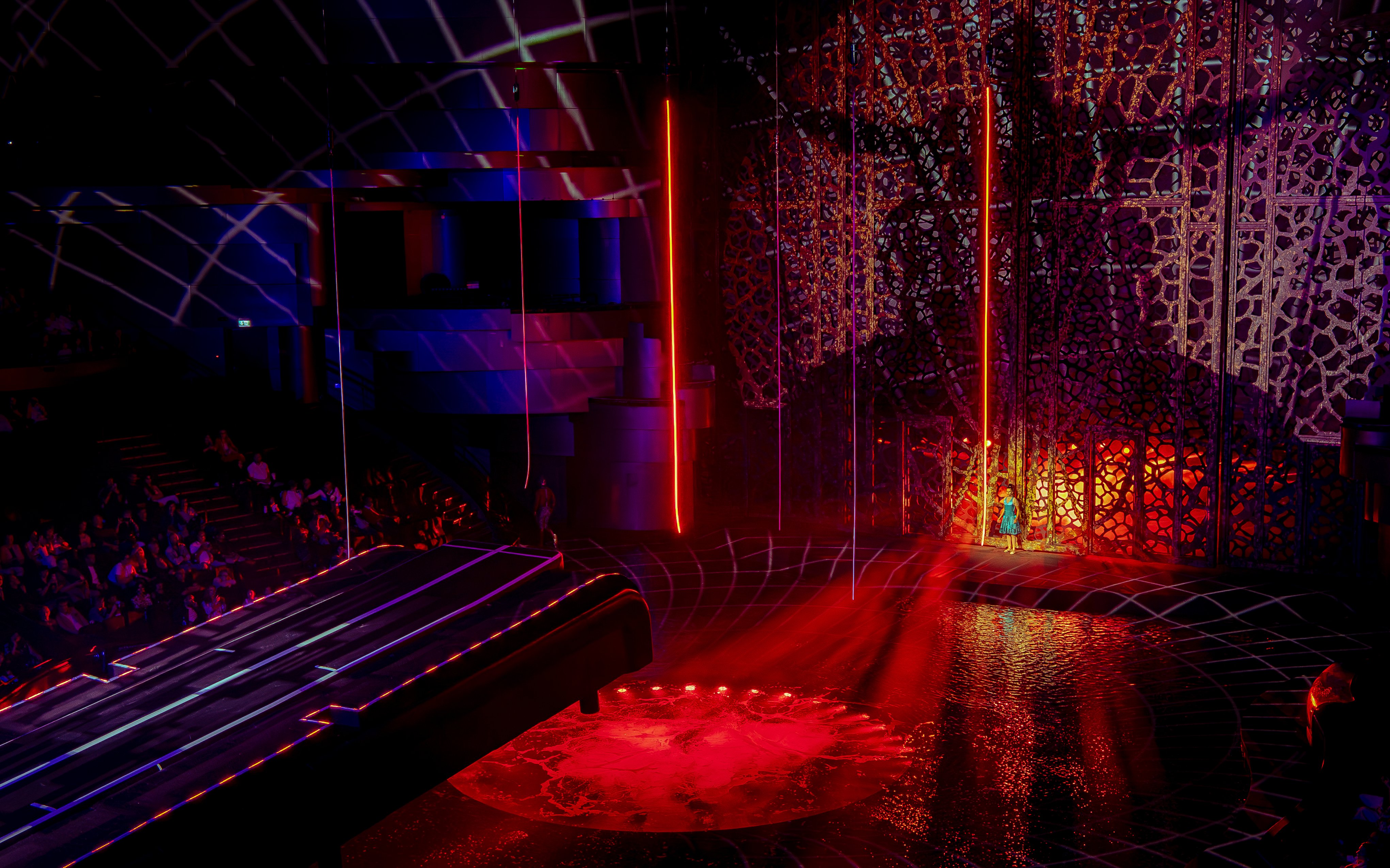 La Perle Dubai stage with vibrant lights and intricate set design.