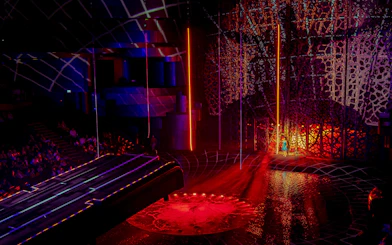 La Perle Dubai stage with vibrant lights and intricate set design.