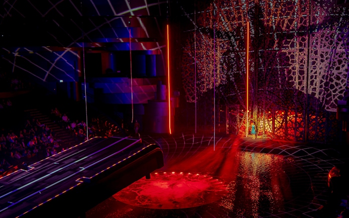 La Perle Dubai stage with vibrant lights and intricate set design.