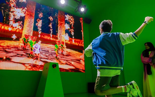 Person interacting with digital art display at House of Hype exhibit.