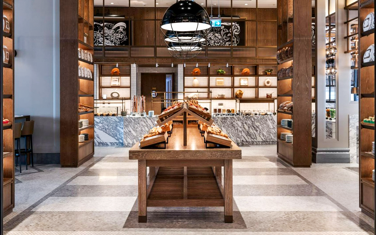 Dining area with wooden tables and shelves at Gastronomy, Dubai.