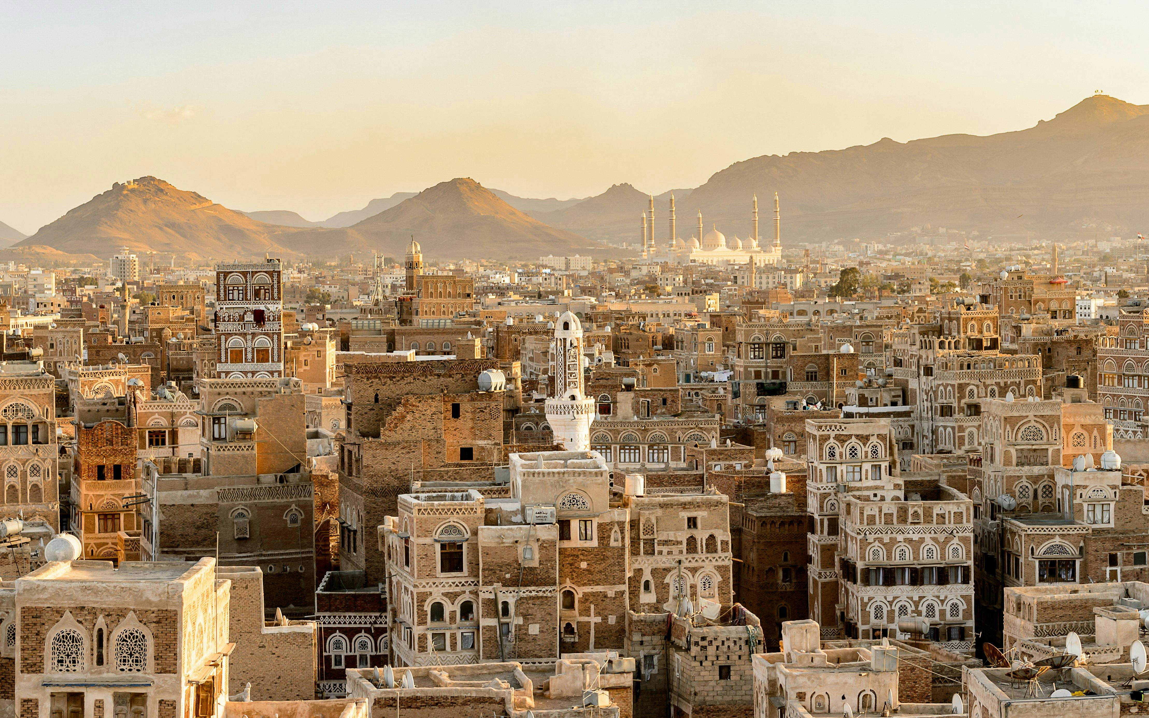 Aerial view of traditional architecture in Amman, Jordan with distant mountains.