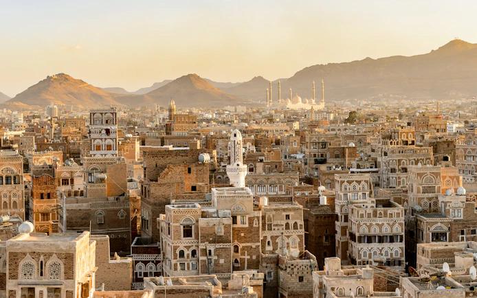 Aerial view of traditional architecture in Amman, Jordan with distant mountains.